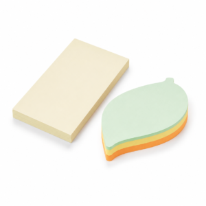 Cream and leaf-shaped adhesive memo pads on a white background